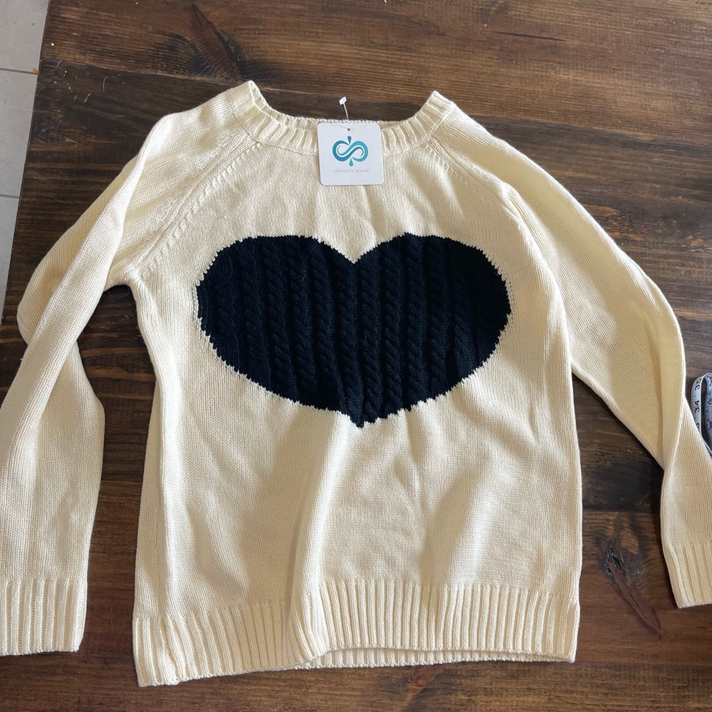 Medium cream colored sweater. Brand new with tags.